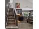 Stylish interior showcasing a carpeted staircase leading to an open kitchen with a bar and seating area at 752 Hobonny Loop, Longs, SC 29568