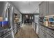 Long shot of a kitchen offering stainless steel appliances, granite countertops and a dining area at 752 Hobonny Loop, Longs, SC 29568