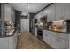 Well-equipped kitchen with stainless steel appliances, granite counters and gray cabinets at 752 Hobonny Loop, Longs, SC 29568