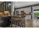Kitchen island features a stone accent wall, barstool seating, and granite countertops at 752 Hobonny Loop, Longs, SC 29568