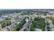 A distant aerial shot displays a community with a pool, pond, and lush foliage near the coastline at 81 Shadow Moss Pl. # 81, North Myrtle Beach, SC 29582