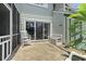 A back patio offers outdoor seating, a sliding door, and a view of the property's serene surroundings at 81 Shadow Moss Pl. # 81, North Myrtle Beach, SC 29582