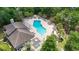 Aerial view of a large community pool with ample seating, surrounded by lush greenery and palm trees at 81 Shadow Moss Pl. # 81, North Myrtle Beach, SC 29582
