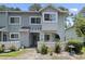 Charming two-story home with light gray siding and a well-manicured front yard with tasteful landscaping at 81 Shadow Moss Pl. # 81, North Myrtle Beach, SC 29582