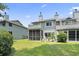 An exterior view shows a two-story home with a screened-in porch and well-maintained lawn at 81 Shadow Moss Pl. # 81, North Myrtle Beach, SC 29582