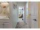 Light-filled hallway leads to a comfortable sitting room and bathroom vanity at 81 Shadow Moss Pl. # 81, North Myrtle Beach, SC 29582