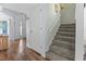 A hallway features wood floors, a stairway, and access to other rooms in the home at 81 Shadow Moss Pl. # 81, North Myrtle Beach, SC 29582