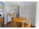 A kitchen with wood floors features white cabinetry, stainless steel appliances, and a round wooden table at 81 Shadow Moss Pl. # 81, North Myrtle Beach, SC 29582