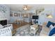 An open-concept living room features light blue walls, hardwood floors, a dining table, and comfortable seating at 81 Shadow Moss Pl. # 81, North Myrtle Beach, SC 29582