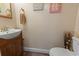 Quaint powder room features a wood vanity and playful beach decor at 81 Shadow Moss Pl. # 81, North Myrtle Beach, SC 29582