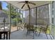 Relax on this screened porch complete with ceiling fan, seating, and view of the backyard at 81 Shadow Moss Pl. # 81, North Myrtle Beach, SC 29582