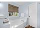 Bathroom with large soaking tub and woven shade at 83 Reef Run Rd., Pawleys Island, SC 29585