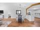 Bright dining area featuring modern light fixture, stylish mirror, and open access to a clean, white kitchen at 83 Reef Run Rd., Pawleys Island, SC 29585