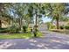 Beautifully landscaped home exterior featuring a two-car garage and mature trees at 83 Reef Run Rd., Pawleys Island, SC 29585