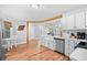Bright eat-in kitchen with a table near the window, stainless fridge, and wood floors at 83 Reef Run Rd., Pawleys Island, SC 29585