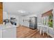 Eat-in kitchen with stainless steel appliances, white cabinets and wood-look flooring at 83 Reef Run Rd., Pawleys Island, SC 29585