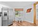 Eat-in kitchen with stainless fridge, window with natural light, and wood-look flooring at 83 Reef Run Rd., Pawleys Island, SC 29585