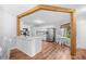 Bright kitchen with white cabinets, stainless steel appliances, and wood-look flooring at 83 Reef Run Rd., Pawleys Island, SC 29585