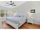 Comfortable main bedroom with a ceiling fan and a large window offering natural light at 83 Reef Run Rd., Pawleys Island, SC 29585