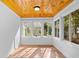 Bright sun room featuring a wood ceiling, white walls, and multiple windows letting in natural light at 83 Reef Run Rd., Pawleys Island, SC 29585