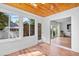 Bright sun room featuring a wood ceiling, white walls, and sliding glass doors to the home's living room at 83 Reef Run Rd., Pawleys Island, SC 29585