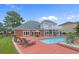 Backyard featuring a swimming pool, patio, lounge chairs, and landscaping, ideal for outdoor living at 904 Kalmia Ct., Myrtle Beach, SC 29579