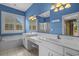Bright bathroom features dual sinks with marble countertops, soaking tub, and separate shower with blue walls at 904 Kalmia Ct., Myrtle Beach, SC 29579