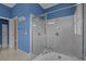 Spacious bathroom showcasing a glass-enclosed shower and bathtub in an area with blue walls at 904 Kalmia Ct., Myrtle Beach, SC 29579