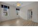 Bright bedroom featuring hardwood floors, ceiling fan, and two windows at 904 Kalmia Ct., Myrtle Beach, SC 29579