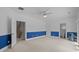 Spacious bedroom with neutral carpet, blue accent wall, and ceiling fan at 904 Kalmia Ct., Myrtle Beach, SC 29579