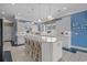 A kitchen with a large central island, white cabinetry, and modern appliances under recessed and pendant lighting at 904 Kalmia Ct., Myrtle Beach, SC 29579
