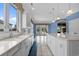 Bright kitchen featuring an island, white cabinets, and large windows leading to an outdoor living space at 904 Kalmia Ct., Myrtle Beach, SC 29579