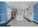 An open kitchen with tiled flooring, white cabinetry, a large island, and modern appliances against blue walls at 904 Kalmia Ct., Myrtle Beach, SC 29579