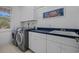 Bright laundry room with cabinets, counter space, sink, and modern washer and dryer at 904 Kalmia Ct., Myrtle Beach, SC 29579