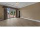 Empty room with hardwood floors, doors leading to patio, neutral colors, and ample natural light at 904 Kalmia Ct., Myrtle Beach, SC 29579