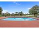 A backyard swimming pool overlooking a tranquil lake surrounded by lush landscaping and neighborhood homes at 904 Kalmia Ct., Myrtle Beach, SC 29579
