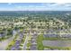 Expansive aerial view showcases a community surrounded by lush greenery and picturesque waterways at 932 Abernathy Place, Surfside Beach, SC 29575