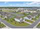 A bird's eye view of a picturesque neighborhood with a scenic pond at 932 Abernathy Place, Surfside Beach, SC 29575
