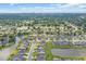 Expansive aerial view showcases a community surrounded by lush greenery and picturesque waterways at 932 Abernathy Place, Surfside Beach, SC 29575