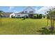 Spacious backyard with lush green lawn, screened in porch, and landscaping for outdoor enjoyment at 932 Abernathy Place, Surfside Beach, SC 29575
