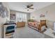 Cozy bedroom features a ceiling fan, neutral walls, and a bright window with stylish shutters at 932 Abernathy Place, Surfside Beach, SC 29575