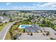Aerial view of a neighborhood community pool and clubhouse, perfect for recreation and relaxation at 932 Abernathy Place, Surfside Beach, SC 29575