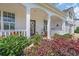 Inviting covered porch with rocking chairs and a decorative wreath, framed by lush landscaping at 932 Abernathy Place, Surfside Beach, SC 29575