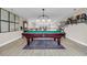 Open concept game room with pool table and elegant light fixture at 932 Abernathy Place, Surfside Beach, SC 29575