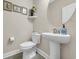 Bright half bathroom featuring a pedestal sink and decorative accents at 932 Abernathy Place, Surfside Beach, SC 29575