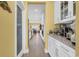 Hallway with kitchen on the right and view of dining room in the distance at 932 Abernathy Place, Surfside Beach, SC 29575