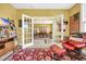 Comfortable living room with bright, natural light, french doors, and seamless access to the dining area at 932 Abernathy Place, Surfside Beach, SC 29575