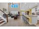 Open-concept kitchen and living room with ample seating, modern fixtures, and a soaring vaulted ceiling at 932 Abernathy Place, Surfside Beach, SC 29575