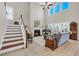 Bright living room features a fireplace, high ceilings, and large windows at 932 Abernathy Place, Surfside Beach, SC 29575
