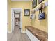 Inviting mud room with a bench, coat rack, and access to the laundry room at 932 Abernathy Place, Surfside Beach, SC 29575